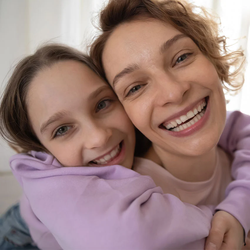 Mom and daughter smiling after orthodontic treatment
